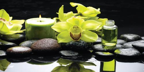 Oriental spa with orchid, candle and pebbles